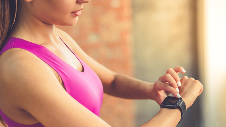 Woman checking Fitbit watch