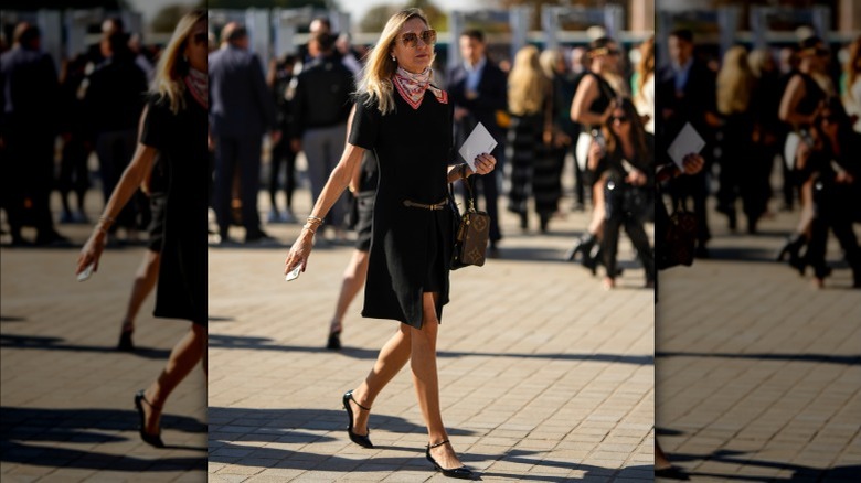 Woman wearing black dress with colorful scarf