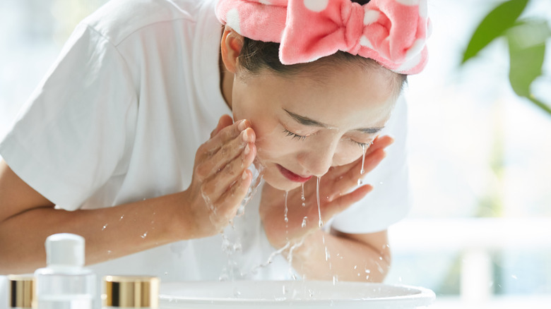 Woman washing face