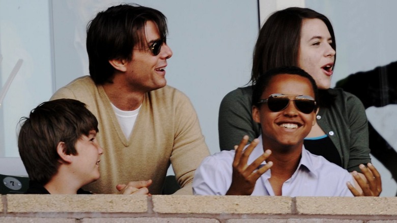 Tom Cruise and kids sitting at event