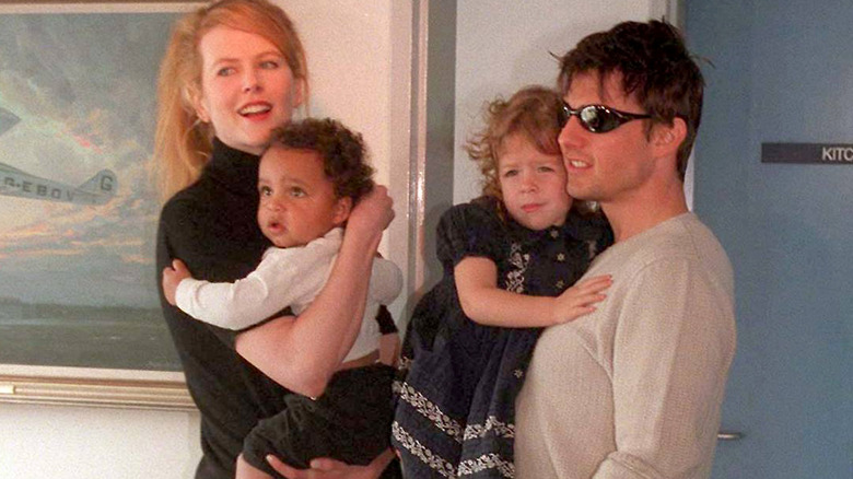 Nicole Kidman and Tom Cruise holding their kids