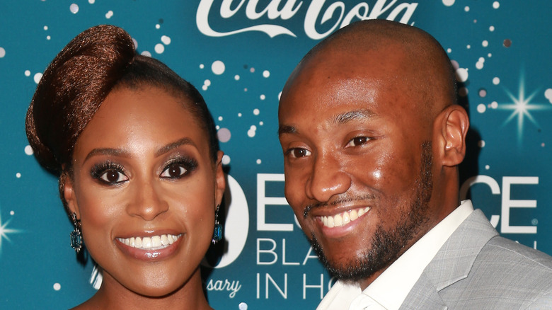 Issa Rae and husband Louis Diame pose together at an event