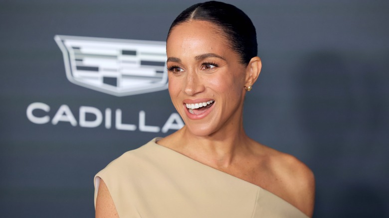 Meghan Markle smiling on the red carpet