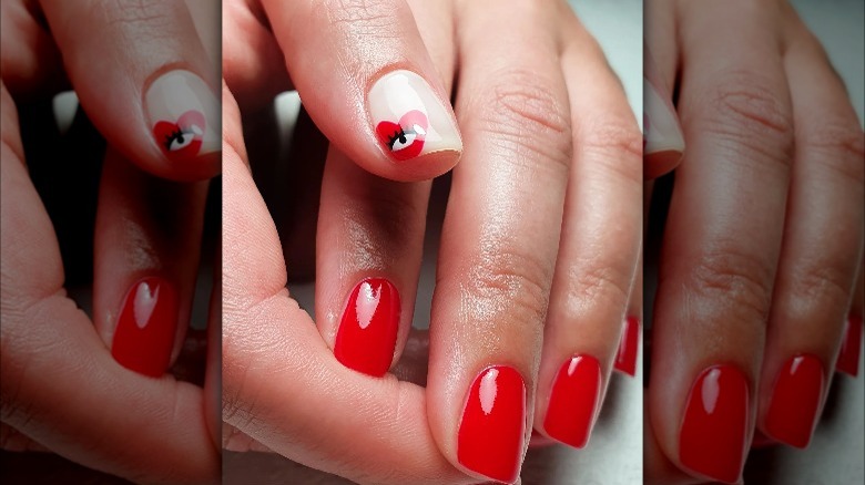 Fingernails painted with red polish