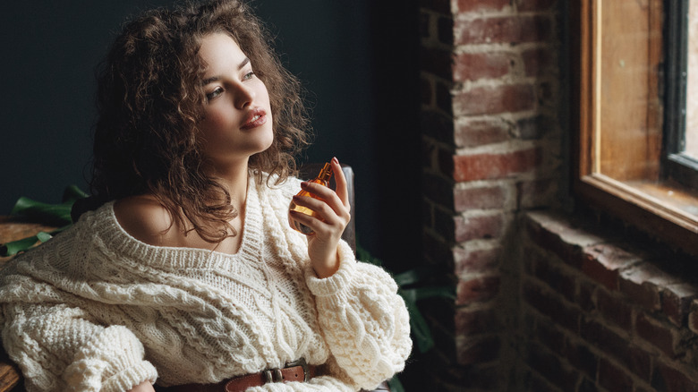 woman spraying perfume