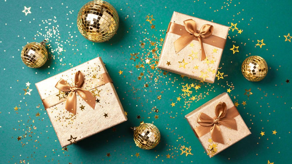 Gift cards wrapped in gold paper with a green background 