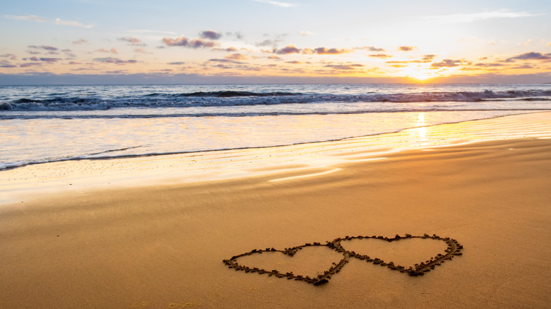 Two hearts drawn in the sand at a beach