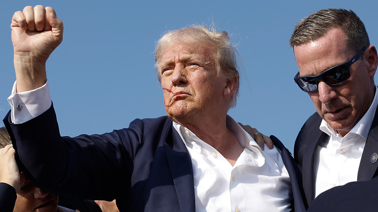 Donald Trump pumps fist after rally shooting