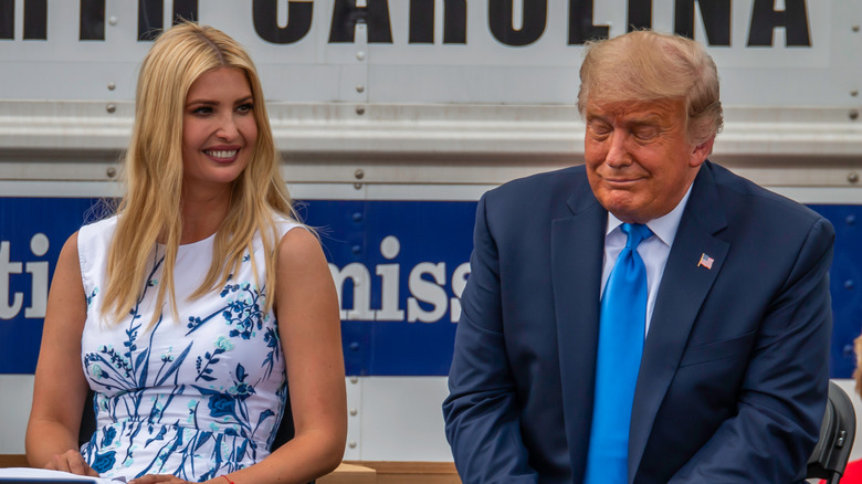 Ivanka Trump sitting next to Donald Trump smiling