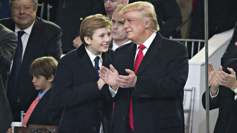 Donald Trump clapping with Barron Trump