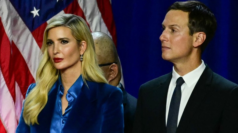 Ivanka Trump and Jared Kushner on stage surrounded by U.S. flags