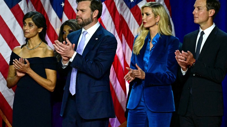 Usha Vance, JD Vance, Ivanka Trump, and Jared Kushner on stage clapping surrounded by U.S. flags