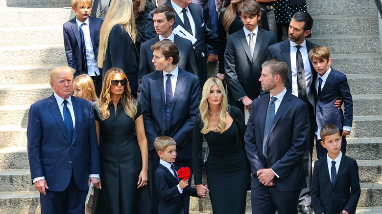 Donald Trump and family posing on stairs