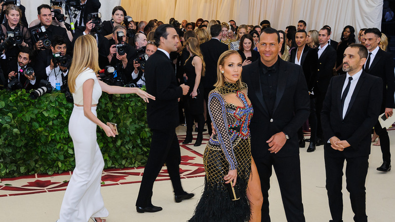 Jennifer Lopez & Alexander Rodriguez pose side by side on a Met Gala carpet