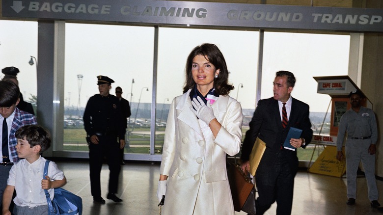 Jackie Kennedy clutching hand to chest