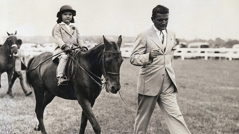 Jacqueline Bouvier on horse led by John Bouvier