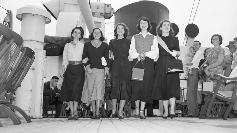 Jacqueline Bouvier standing with group on ship