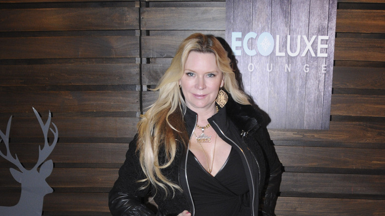 Jackie Siegel by wooden wall