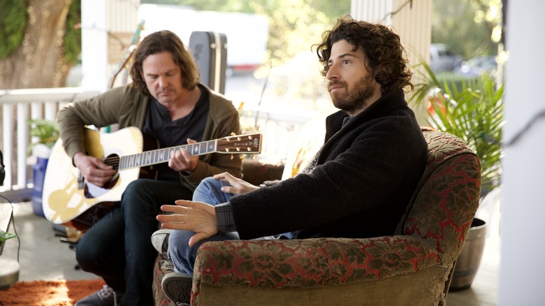 Jake Hoffman sitting on porch in Sam & Kate