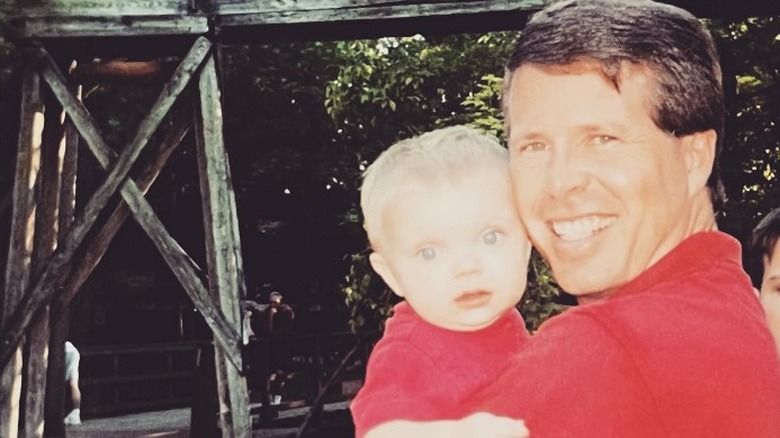 Jim Bob Duggar holding toddler James Duggar