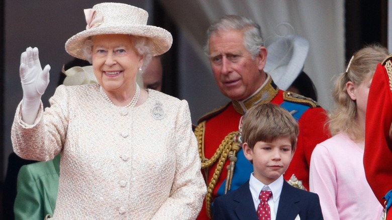 Queen Elizabeth II, King Charles III, and James posing