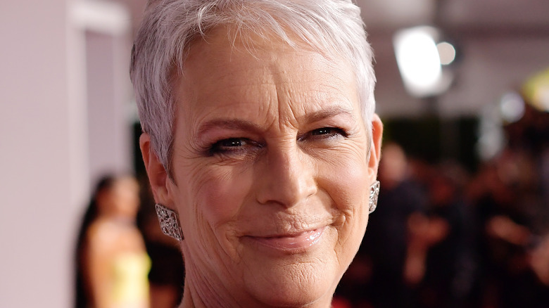 Jamie Lee Curtis looks over her shoulder at an event