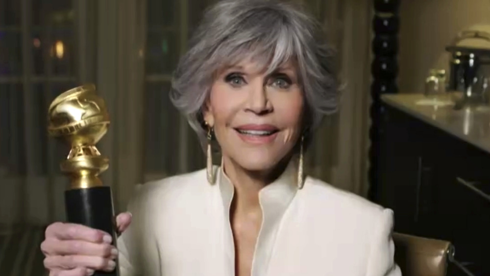 Jane Fonda holding her Golden Globe