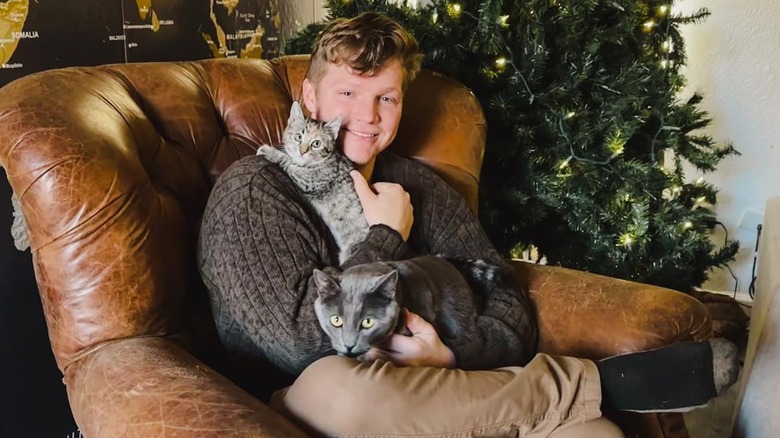 Garrison Brown holding his cats