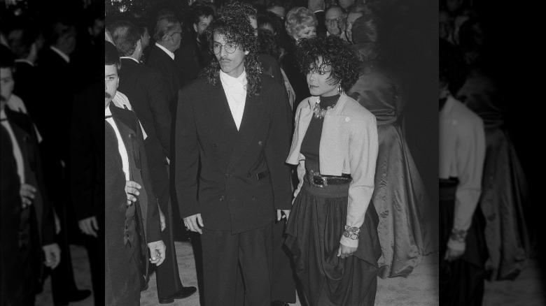 René Elizondo Jr. and Janet Jackson posing together at an event