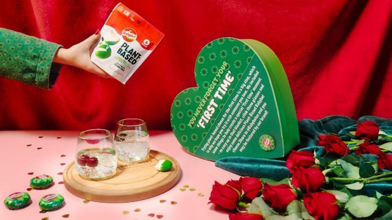 Vegan Babybel cheese with green heart-shaped box, roses, and drinks