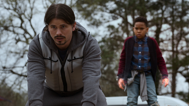 Jason Ritter and Ja'Siah Young standing outside