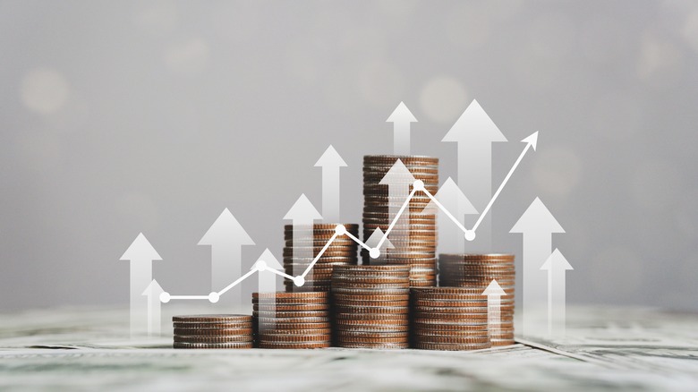 Stacks of coins with arrow chart