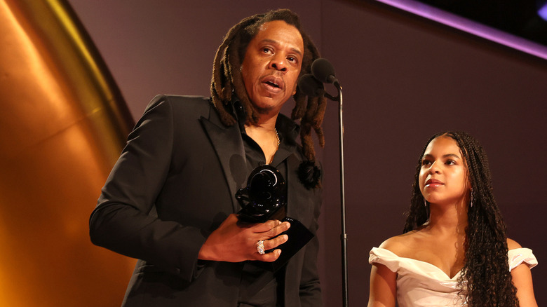 Jay accepting a Grammy award with his daughter Blue Ivy