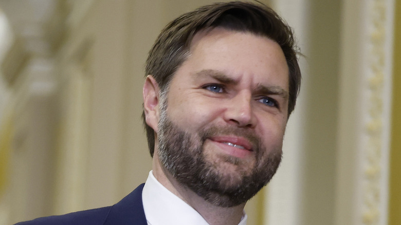 JD Vance half-smiling in a blue suit