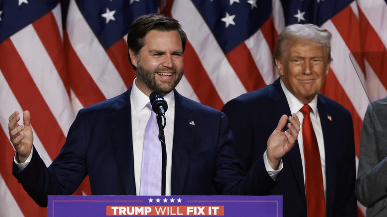 Trump awkwardly smiling next to JD Vance