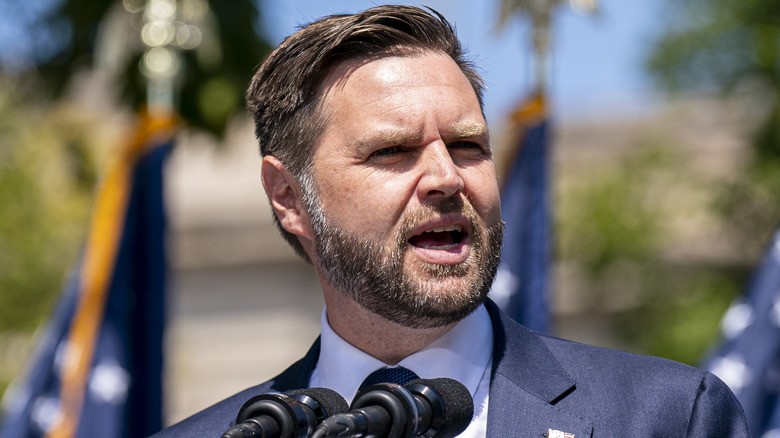 JD Vance outside behind microphones