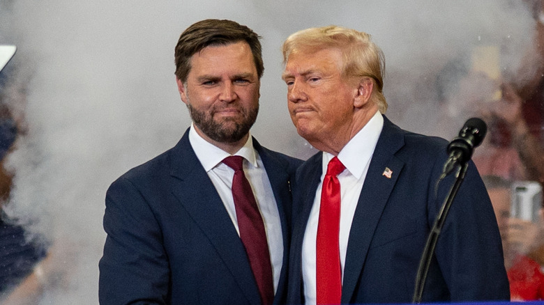 JD Vance and Donald Trump awkwardly standing next to each other on stage