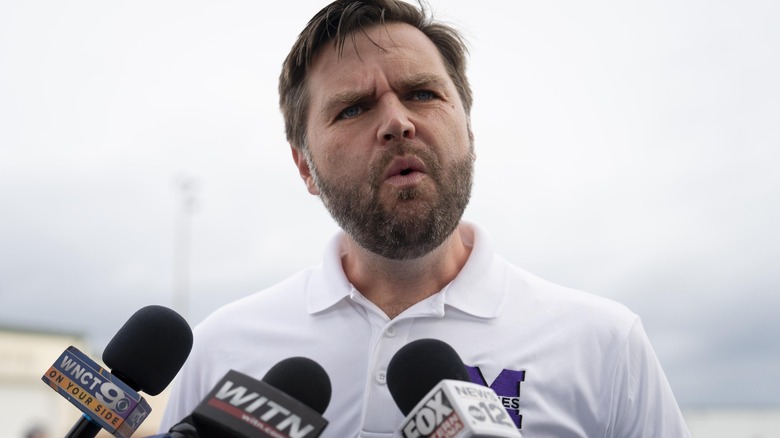 JD Vance speaking into multiple microphones