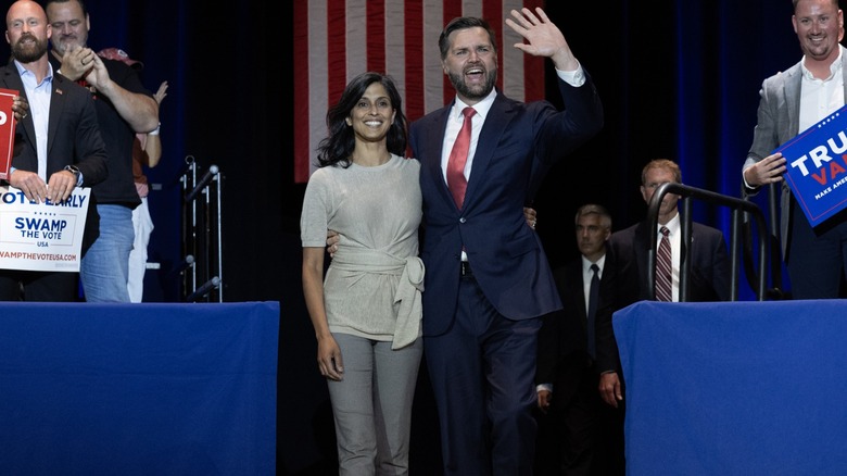 JD Vance waving with his arm around Usha Vance