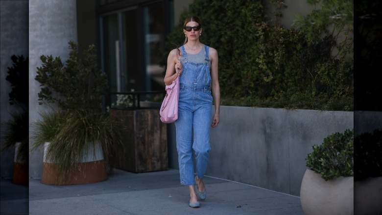 woman wearing overalls and tank top