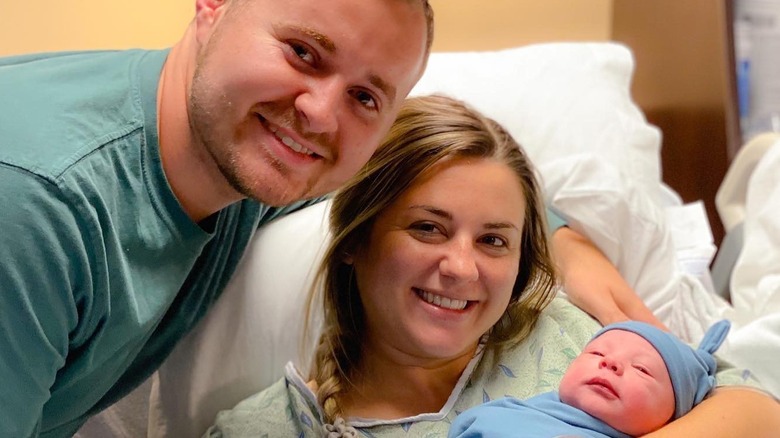 Jed, Katey, and their son posing