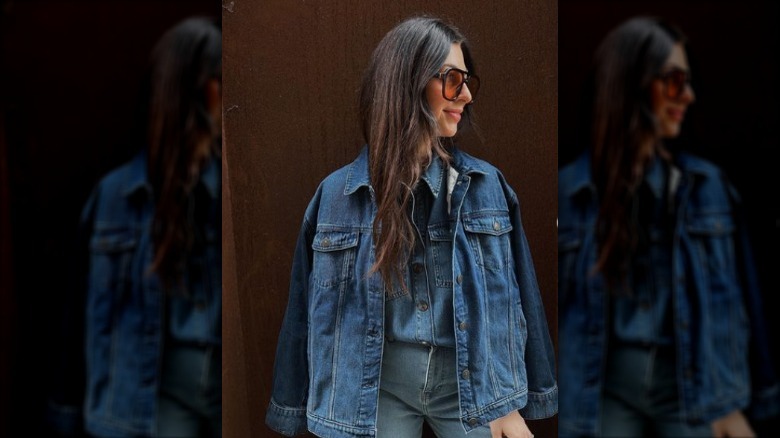 woman posing in denim jacket