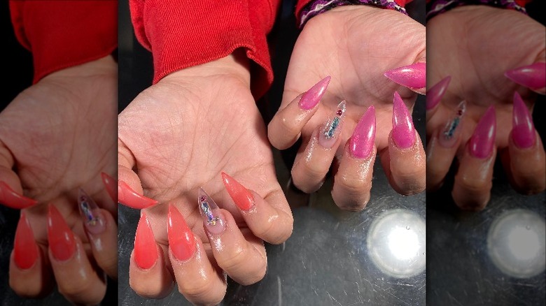 Hands showing off bold pink and orange manicure