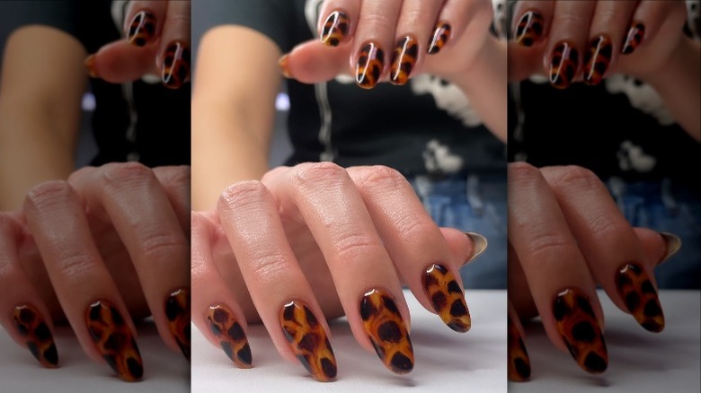 Hands with shiny tortoiseshell nail art