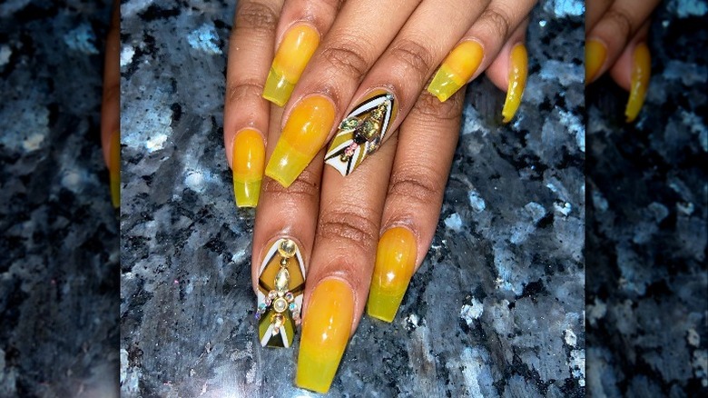 Hands with bold yellow manicure