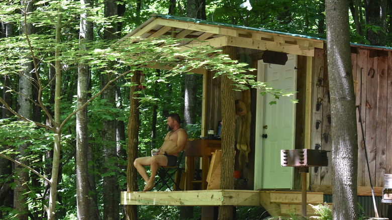 Charlie sitting on front porch of his house