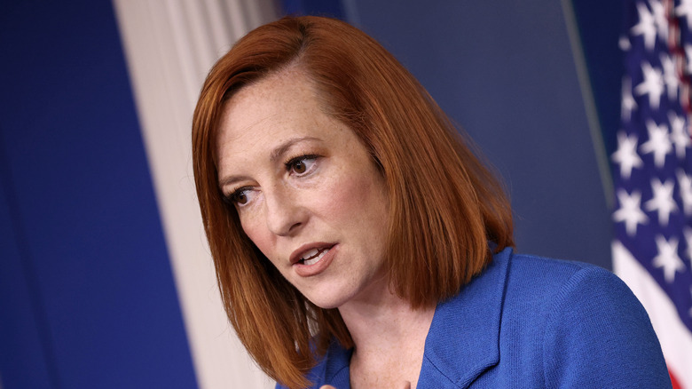 Jen Psaki at a press conference in blue blazer