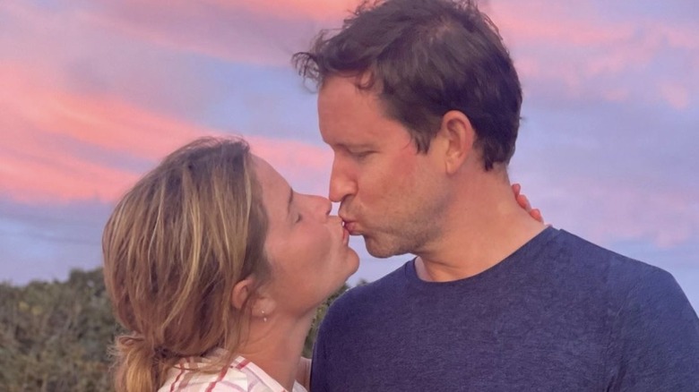 Jenna Bush Hager kissing Henry Hager against pink sky