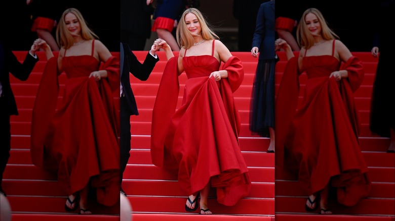 Jennifer Lawrence black flip flops under red gown