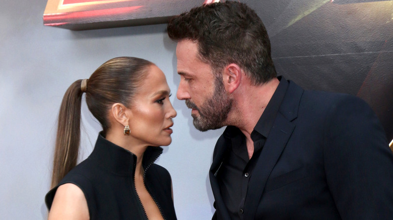 Jennifer Lopez and Ben Affleck looking concerned at a red carpet event